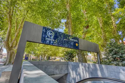 a blue sign on top of a concrete bench at OPORTO GUEST Marquês Square in Porto