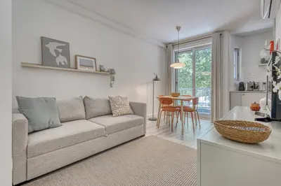 a living room with a couch and a table at OPORTO GUEST Marquês Square in Porto