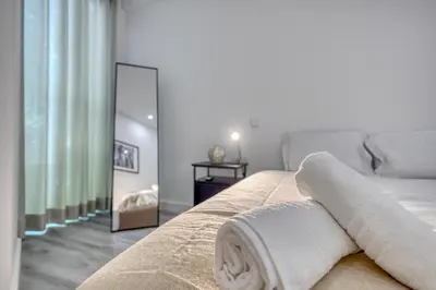 a bedroom with a bed with towels on it at OPORTO GUEST Marquês Square in Porto