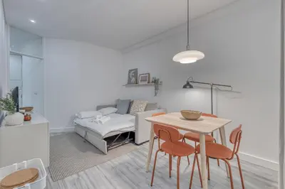 a living room with a table and chairs and a couch at OPORTO GUEST Marquês Square in Porto