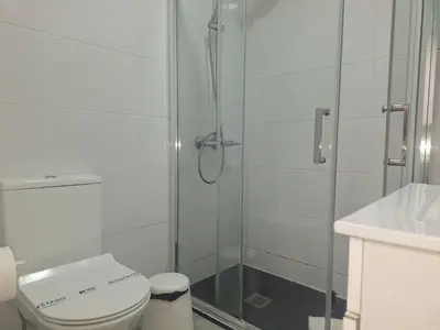 a bathroom with a shower with a toilet and a sink at porto true confession in Porto