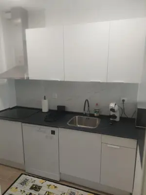 a kitchen with white cabinets and a sink at RIVER VIEW TMB oporto station house in Porto