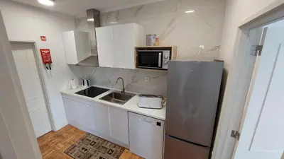 a kitchen with a stainless steel refrigerator and a microwave at RIVER VIEW TMB oporto station house in Porto