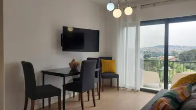 a living room with a dining room table and chairs at RIVER VIEW TMB oporto station house in Porto