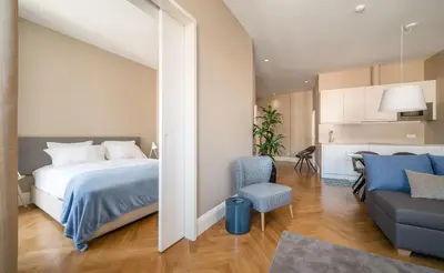 a bedroom with a bed and a living room at Mouzinho 160 in Porto