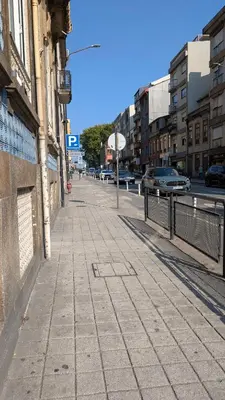 an empty city street with cars on the road at Riko Guesthouse in Porto