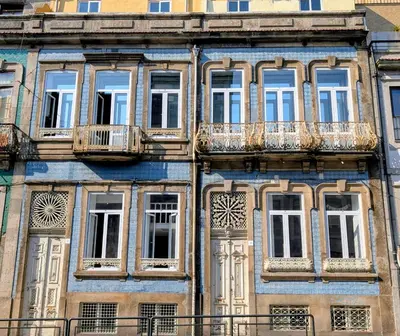 an old building with windows and balconies at Riko Guesthouse in Porto