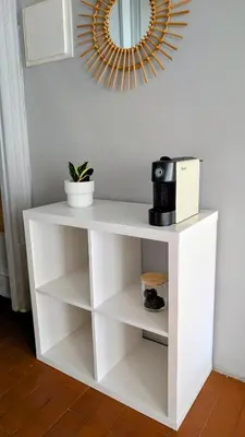 a white shelf with a microwave and a mirror at Riko Guesthouse in Porto