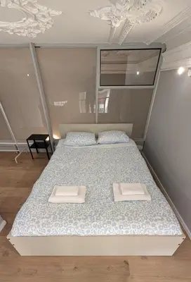 a bedroom with a bed with two towels on it at Riko Guesthouse in Porto