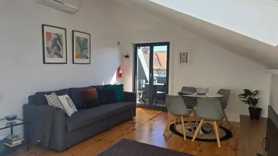 a living room with a couch and a table at Fontainhas Sunny Rooftop with balcony in Porto