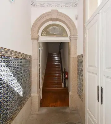 a hallway with a staircase in a home with a stair case at Top of the World by Upperground in Porto