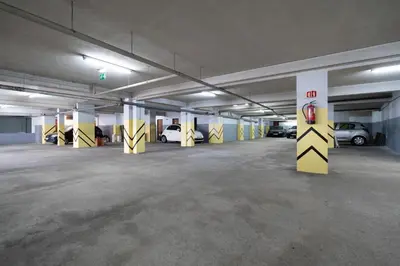 an empty parking garage with cars parked in it at Stylish Flat with Workspace & Garage by HostWise in Porto