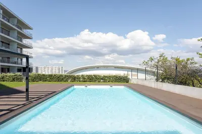 a swimming pool on the side of a building at Studio w/ Balcony, Pool & Gym in Antas by HostWise in Porto