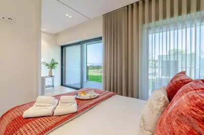 a bedroom with a bed and a large window at Studio w/ Balcony, Pool & Gym in Antas by HostWise in Porto
