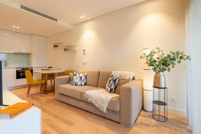 a living room with a couch and a table at Studio w/ Balcony, Pool & Gym in Antas by HostWise in Porto