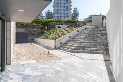 a set of stairs with a building in the background at Studio w/ Balcony, Pool & Gym in Antas by HostWise in Porto