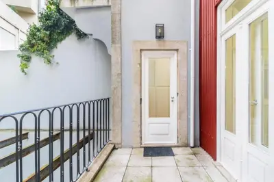 a white door on a white building with a red at Avantgarde by Upperground in Porto