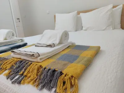 a bed with a blanket and pillows on it at Avantgarde by Upperground in Porto