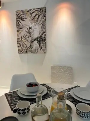 a table with plates and a bowl of fruit on it at Douro River by Upperground in Porto