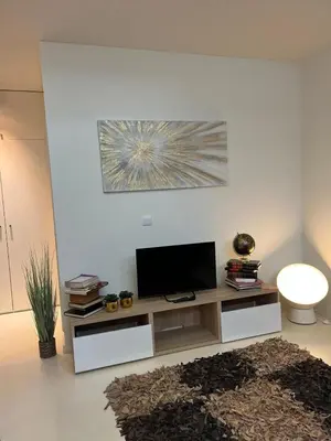 a living room with a tv on a white wall at Douro River by Upperground in Porto