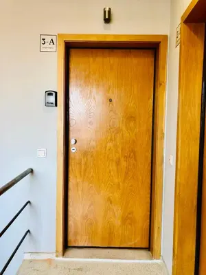 a wooden door in a room with a staircase at YOUROPO - Clerigos in Porto