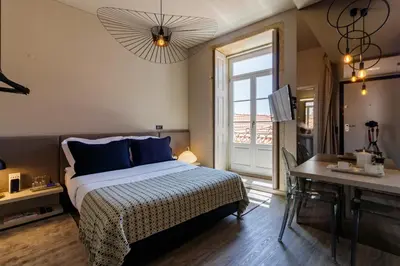 a bedroom with a bed and a desk and a window at YOUROPO - Clerigos in Porto