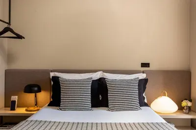 a bedroom with a bed with black and white pillows at YOUROPO - Clerigos in Porto