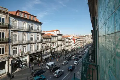 a busy city street with cars parked on the street at YOUROPO - Clerigos in Porto