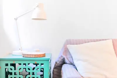 a lamp on a table next to a bed with a pillow at KOPKE 113, local & spacious 2Bed in Porto