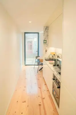 a kitchen with a hard wood floor and a table at Porto Breeze 2 in Porto