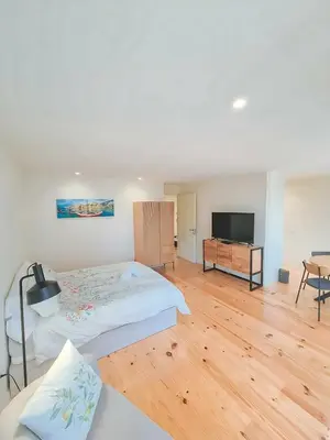 a bedroom with a bed and a flat screen tv at Porto Breeze 2 in Porto