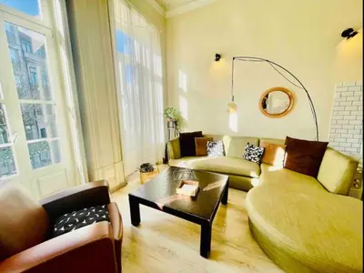 a living room with a couch and a coffee table at Ai Porto! Books&Roots in Porto