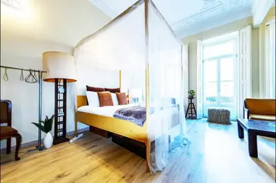 a bedroom with a canopy bed in a room at Ai Porto! Books&Roots in Porto