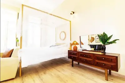 a bedroom with a bed and a dresser with a mirror at Ai Porto! Books&Roots in Porto