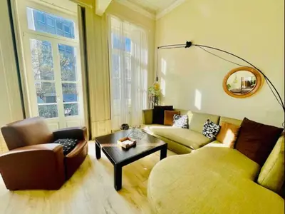 a living room with a couch and a table at Ai Porto! Books&Roots in Porto