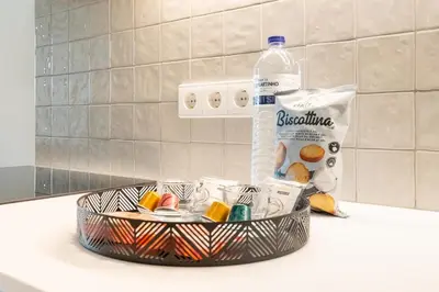 a basket with a bottle of water and some candy at Sao Bento Luxury Hideaway 2 Bedroom Downtown Porto in Porto
