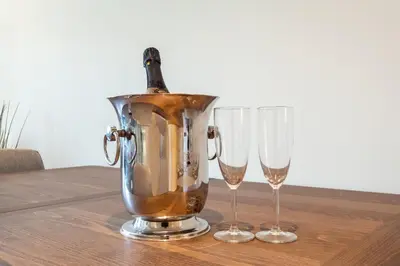a copper blender with two wine glasses on a table at Sao Bento Luxury Hideaway 2 Bedroom Downtown Porto in Porto