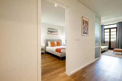 a bedroom with a bed and a large mirror at Sao Bento Luxury Hideaway 2 Bedroom Downtown Porto in Porto