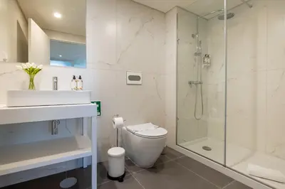a bathroom with a shower and a toilet and a sink at Sao Bento Luxury Hideaway 2 Bedroom Downtown Porto in Porto