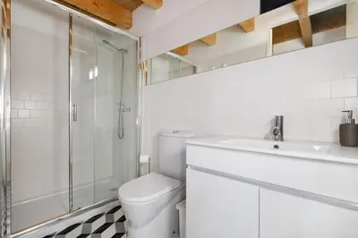 a bathroom with a toilet and a shower and a sink at Cool Alegria Loft Mezzanine Retreat in Porto