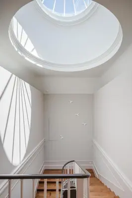 a large skylight in a room with a stair case at Baumhaus Serviced Living - Art & Design Apartments in Porto