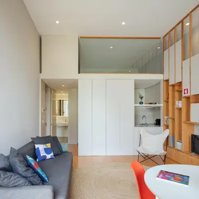 a living room with a couch and a table at Baumhaus Serviced Living - Art & Design Apartments in Porto