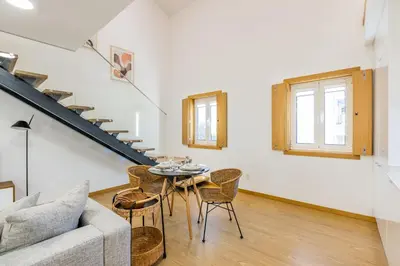 a living room with a couch and a tv at Inner Center Porto in Porto
