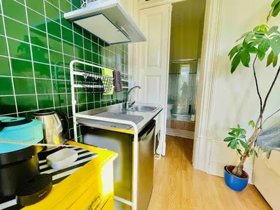 a green tiled kitchen with a sink and a stove at Ai Porto! Gold&Soul in Porto