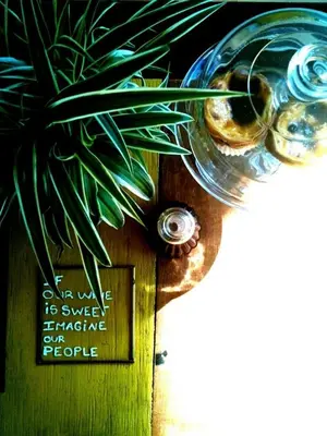 a glass vase with a plant next to a sign at Ai Porto! Gold&Soul in Porto