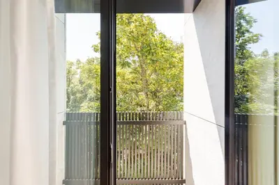 a window with a bench looking out at a tree at GuestReady - Gracious City Escape in Porto in Porto