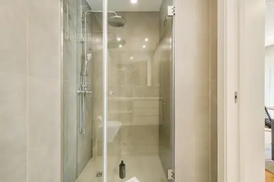 a shower with a glass door in a bathroom at GuestReady - Gracious City Escape in Porto in Porto