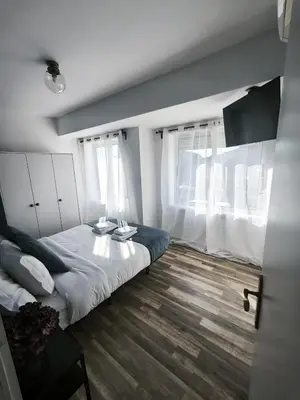 a bedroom with a bed and a table and windows at Best Deal Porto Apartment - Porto Velho Apt in Porto