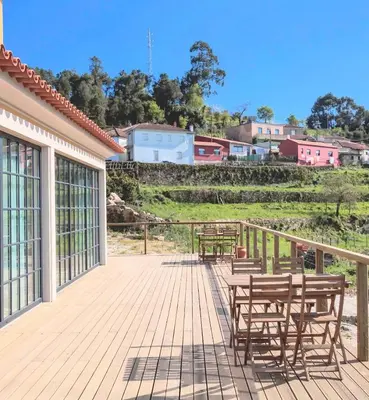 a wooden deck with benches and tables on it at Quinta de Sá in Vila Nova de Gaia