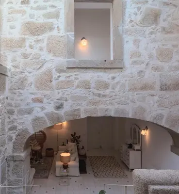 a room with a stone wall with a window at Quinta de Sá in Vila Nova de Gaia